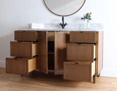 a bathroom vanity with drawers and a mirror