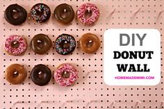 there are many donuts on the wall and one has chocolate, sprinkles