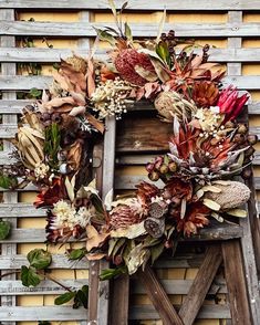 a wooden chair with a wreath on top of it