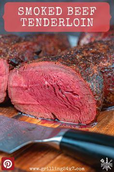 a close up of some meat on a cutting board with a knife next to it