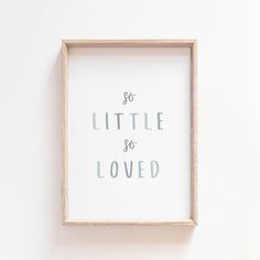 a wooden frame with the words so little and loved on it hanging on a wall