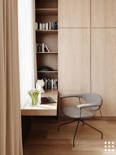 a chair and desk in front of a book shelf