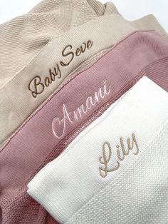 three personalized towels are stacked on top of each other, one with the word baby seve written on it