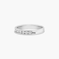 a white gold ring with five diamonds on the side, set in 18k white gold