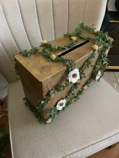 a wooden box sitting on top of a white chair