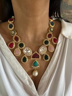 All our pieces are in stock and will be dispatched within 24 to 48 hours of order. Orders received during the weekend will be dispatched on Monday One of our favorite picks for the wedding season ❤️ Comes with an adjustable string. Material: Brass and copper mix, gold polish, CZ stones, Polki Kundan, carved Quartz stones, pearls Dimensions Weight of Necklace is 90 g. Drop Length of Necklace: 11 inches Necklace comes with adjustable Dori. Weight of Earrings is 22 g per pair. Length of Earrings: 5 cms, push back closure. Width of Earrings: 3.5 cms. Gold Jeweled Necklaces For Reception, Gold Earrings With Stones For Festive Occasions, Gold Jeweled Bridal Necklace For Reception, Multicolor Jeweled Bridal Necklace For Festive Occasions, Gold Kundan Necklace With Stones In Temple Jewelry Style, Gold Chandbali Bridal Necklace Jeweled, Gold Kundan Necklace With Stones For Formal Occasions, Fusion Style Festive Kundan Necklace With Jewels, Celebration Multicolor Kundan Necklace Gold Plated