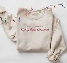 Festive minimalist EMBROIDERED Merry Christmas Sweatshirt. I have this sweatshirt with red embroidery as well: https://studioesmerose.etsy.com/listing/1558740458 A sturdy and warm sweatshirt bound to keep you warm in the colder months. A pre-shrunk, classic fit sweater that's made with air-jet spun yarn for a soft feel and reduced pilling. * 50% cotton, 50% polyester * Pre-shrunk * Classic fit * 1x1 athletic rib knit collar with spandex * Air-jet spun yarn with a soft feel and reduced pilling * Double-needle stitched collar, shoulders, armholes, cuffs, and hem This product is made especially for you as soon as you place an order, which is why it takes us a bit longer to deliver it to you. Making products on demand instead of in bulk helps reduce overproduction, so thank you for making thou Christmas Sweatshirt Ideas, Merry And Bright Christmas, Minimal Christmas, Womens Christmas Shirts, Bright Christmas, Red Embroidery, Holiday Sweatshirt