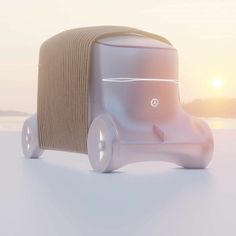 a small white car sitting on top of a beach next to the ocean at sunset