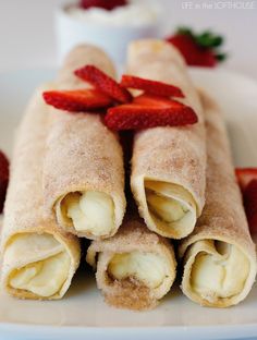 some food is on a white plate with strawberries