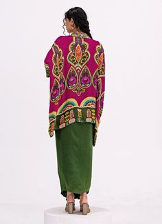 This vibrant Rani Pink and Green Embroidered Toga Kurta Dhoti Set showcases a rich blend of colors and patterns for an elegant, modern ethnic look. The striking rani pink kurta is crafted from soft crepe fabric and features a beautifully detailed paisley design, while its asymmetrical hemline brings a contemporary twist. Paired with flowy green dhoti pants, this indo western style ensures both comfort and ease of movement, making it ideal for festive celebrations or casual family gatherings. Composition : Top and Pants - Crepe Care: Dry Clean Only and Vacuum Storage This product can be customized for sleeves, blouse length and neckline Delivery : 4-6 weeks as the product is hand crafted. Check Size Guide or choose MySize for free customisation (All Sizes above XL can be made at 15% additio Pink Kurta, Rani Pink, Dhoti Pants, Vacuum Storage, Indian Wedding Wear, Ethnic Looks, Sleeves Blouse, Indo Western, Paisley Design