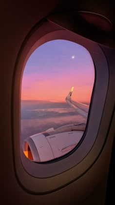 an airplane window looking out at the sky