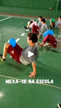 a group of young men playing a game of frisbee on a gym floor