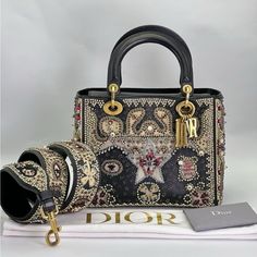 Pre-Owned Christian Dior Calfskin Beaded Medium Lady Dior Black Multicolor Description This Is An Authentic Christian Dior Calfskin Beaded Medium Lady Dior In Black And Multicolor. This Stylish Tote Is Crafted With A Multicolored Beaded Embroidered Scene Throughout The Entire Bag. The Bag Features Black Leather Top Handles, An Optional Beaded Shoulder Strap With Polished Gold Hardware Including Wide Eyelets And Dior Letter Charms. The Top Is Open To A Black Suede Interior With Zipper And Patch Pockets. Conditions: Very Good Or Rank + Exterior: Scuffs, Marks, Imprints, Frayed Stitch(Es) Handle: Scuffs, Marks, Frayed Stitch(Es) Interior: Scuffs, Surface Wear, Marks, Imprints Hardware: Scrat Black Leather Top, Letter Charms, Lady Dior, Leather Top, Dior Bag, Black Suede, Gold Hardware, Patch Pocket, Christian Dior