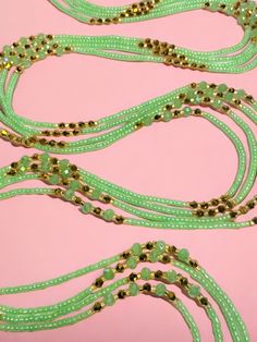 Single Strand Waist Bead, featuring delicate seafoam green glass seed beads accented with luxurious gold crystal glass beads. Why You'll Love It: Subtle Elegance: Seafoam green glass seed beads offer a soft, soothing sparkle that complements any outfit. Luxurious Accents: Gold crystal glass beads add a touch of sophistication and opulence. Perfect Fit: The adjustable single strand design ensures comfort and a secure fit for all body types. Cultural Beauty: This piece blends the rich heritage of Handmade Green Waist Beads, Gold Beaded Bracelets For Summer Parties, Bohemian Green Beaded Bracelets With Gold Beads, Gold Spacer Beads Jewelry For Summer, Adjustable Green Beaded Bracelets With Gold Beads, Festive Green Beaded Bracelets With Colorful Beads, Festive Green Beaded Bracelets, Green Beaded Chain Bracelets For Beach, Gold Beaded Chain For Summer