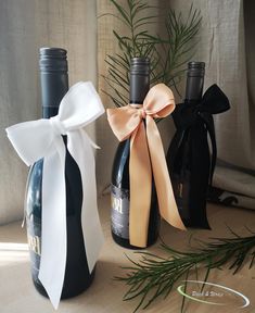 three bottles of wine tied with ribbons