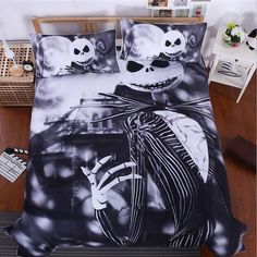 the bedding is decorated with black and white designs, including two jack - o'- lanterns