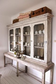 an old china cabinet with glass doors and drawers in the middle is featured on instagram