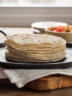 a stack of tortillas sitting on top of a pan