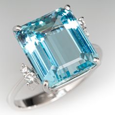 This well-crafted cocktail ring is centered with one (1) emerald cut natural aquamarine set into four-prongs. The shoulders of the ring are each accented with two (2) prong set round brilliant cut diamonds. The ring measures 13.3mm at the top, rises 9.6mm above the finger, tapering to 2.7mm wide and 1.3mm thick at the base of the shank. The ring is crafted in platinum and is currently a size 7.75. "72068" is engraved on the inside of the shank. Antique Cocktail Ring, Aquamarine Ring Vintage, Antique Engagement Rings Sapphire, Aquamarine Cocktail Ring, Estate Jewelry Rings, Wedding Ring Diamond Band, Vintage Cocktail Ring, Aquamarine Jewelry, Aquamarine Ring