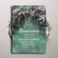 a green and purple wedding card with lights on the top, surrounded by branches in front of it