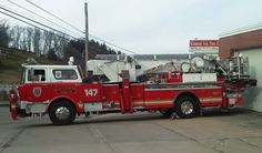 a red fire truck parked in front of a building