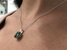 Featured here is a stunning oval emerald necklace in fine .925 sterling silver. Displayed in the center is a rich-green emerald accented by a floral four-prong silver mount, allowing for the emerald to be shown in full view. Minor flaws are normal and add to the beauty of this earthy piece. The earth mined, green Colombian emerald has a desirable lush green color with excellent qualities. An 18-inch sterling silver chain will be provided with this beautiful pendant! This necklace is ideal for ev Oval Emerald Gemstones With Accents, Formal Oval Pendant Emerald Birthstone Necklace, Formal Oval Pendant Emerald Necklace As Birthstone, Formal Oval Pendant Emerald Necklace, Formal Emerald Oval Pendant Birthstone Necklace, Formal Emerald Oval Pendant Necklace Birthstone, Oval Emerald Necklace With Prong Setting For May Birthstone, Oval Hallmarked Emerald Necklace Gift, Oval Emerald Necklace With Natural Stones For Gift