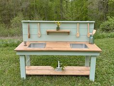 an outdoor kitchen made out of old pallets with sink and countertop in the grass