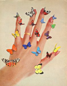 a woman's hand with many colorful butterflies on it