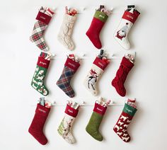 twelve christmas stockings hung on a clothes line