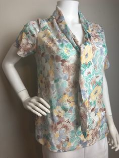 "Vintage 1970s Floral Top Brown Green Blue Yellow Blouse Shirt with Tie Scarf Gorgeous top in excellent vintage condition. The scarf is connected to the collar.  Measurements flat: Pit to pit: 18\" Shoulder to shoulder: 17\" Length: 24\"" Shirt With Tie, Tie Scarf, Yellow Blouse, Blouse Shirt, Star Shirt, Floral Top, Vintage 1970s, Womens Clothing Tops, Blue Yellow