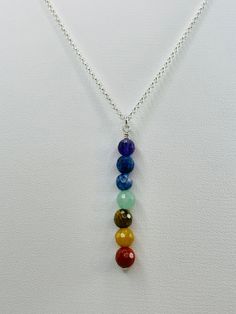 "Nervous about buying from a new shop? Don't be! We have the support of YMC Jewelry with OVER 6K SALES and 5★ REVIEWS! Sterling Silver 7 Chakra Necklace,Seven Chakra Necklace,Healing Crystals Necklace,Stacking Layering Necklace,Healing Gemstone Necklace This beautiful and delicate Sterling silver chakra necklace was made with 16\" inches rolo chain and 8mm faceted Amethyst, Lapis Lazuli, Sodalite, Green Aventurine, Tiger's Eye, Yellow Jade, Red Jasper. The pendant measure about 2\" inches long. Spiritual Sterling Silver Crystal Necklace With Gemstone Beads, Sterling Silver Crystal Necklace With Gemstone Beads For Meditation, Spiritual Crystal Necklace With Gemstone Beads And Round Pendant, Sterling Silver Gemstone Beads Necklace For Meditation, Spiritual Round Pendant Crystal Necklace With Gemstone Beads, Spiritual Crystal Necklace With Round Gemstone Pendant, Spiritual Pendant Crystal Necklace With Polished Beads, Rainbow Spiritual Jewelry For Healing, Sterling Silver Crystal Necklaces For Meditation