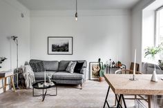 a living room filled with furniture and lots of windows