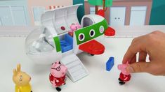 the peppa pig plays with his toy airplane and other toys in front of him