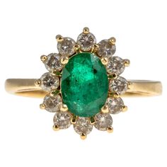 an emerald and diamond cluster ring