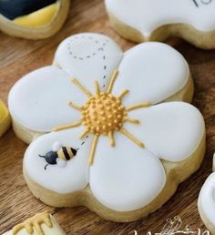 decorated cookies with flowers and bees on them