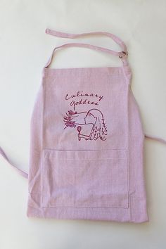 a pink apron with an image of a horse on the front and writing that says, congratulations gardener