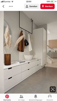 a hallway with white cabinets and coat racks