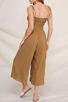 This gorgeous piece offers effortless elegance with its luxurious bamboo-textured fabric, ensuring a soft, breathable feel against your skin. Fully lined for extra comfort and coverage, it features chic tie straps that let you customize the fit. Perfect for those warm summer days and breezy evenings, this jumpsuit effortlessly transitions from casual outings to dinner dates. Pair it with your favorite sandals or dress it up with statement jewelry. Get ready to turn heads and feel fabulous all su Maxi Jumpsuit, Dinner Dates, Cut Clothes, Flat Heel Boots, Thermal Sweater, American Jeans, Beanie Style, Sneaker Slippers, Effortless Elegance