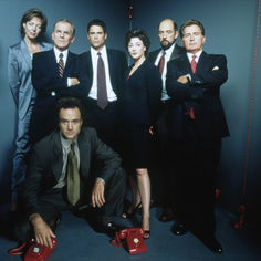 a group of people in suits and ties posing for a photo