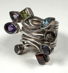 Sterling silver multi-stone ring. Size 9. Excellent condition. Modern Multi-stone Sterling Silver Gemstones, Modern Multi-stone Gemstones In Sterling Silver, Unique Multi-stone Open Crystal Ring, Modern Silver Rings With Natural Stones, Silver Multi-stone Ring Gemstones, Silver Multi-stone Stackable Rings Fine Jewelry, Silver Stackable Rings With Multi-stone, Silver Multi-stone Stackable Rings In Fine Jewelry Style, Silver Stackable Rings With Multi-stones In Fine Jewelry Style