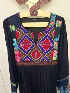 Vintage hippy dress in thick dark blue cotton with contrasting pink/blue floral panels.  The dress has a beautiful intricate geometric  embroidered front bib finished with layers of cross stitch.  The overall shape is so flattering. The dress has butterfly open sleeves. In fabulous condition.  Would probably fit a size 8/10 UK but please look at the measurements carefully as these dresses are not a standard size.  Bust to 42 cm Shoulder to bottom hem 116 cm Traditional Patchwork Dress For Summer, Traditional Dress With Multicolor Embroidery And Patchwork, Traditional Blue Dress With Embroidered Sleeves, Long Sleeve Dress With Geometric Embroidery For Festival, Folk Style Dress With Multicolor Embroidery And Long Sleeves, Folk Style Long Sleeve Dress With Embroidered Neckline, Bohemian Long Sleeve Embroidered Cotton Dress, Bohemian Dress With Multicolor Embroidery And Embroidered Sleeves, Bohemian Embroidered Dress With Embroidered Sleeves For Festival