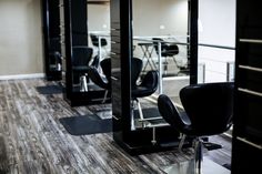 an empty salon with chairs and mirrors