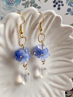 Embrace the timeless beauty of these handmade earrings adorned with delicate little blue "Forget Me Not" flowers, symbolizing love and fidelity.  Suspended from each blossom, glistening crystal drops add a touch of sparkle and allure. With their understated charm and handmade craftsmanship, they make a captivating addition to any ensemble, infusing it with grace and romance. A perfect gift for her, these earrings exude elegance, making them an exquisite choice for bridal wear or as a captivating Blue Flower Earrings For Jewelry Making, Blue Drop Flower Earrings With Ear Wire, Blue Drop Flower Earrings, Delicate Blue Flower Shaped Earrings, Delicate Blue Flower-shaped Earrings, Blue Dangle Flower Earrings, Handmade Light Blue Drop Flower Earrings, Handmade Blue Teardrop Crystal Earrings, Delicate Blue Flower Earrings With Ear Wire