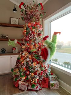 a christmas tree decorated with candy canes, candies and other holiday decor items