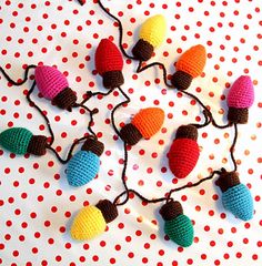 crocheted christmas lights are displayed on a polka dot tablecloth with red, white and blue dots