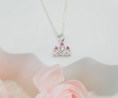 Fun and playful princess tiara charm necklace for toddlers and little girls.  This delightful tiara charm is accented with sparkling pink and clear CZs for that bling they love and comes with the option of adding a hand-made wire wrapped freshwater pearl charm ...the perfect gift for your little princess!  Great gift for princess birthday parties, party favor, or for that granddaughter that loves to sparkle! 🌸 This comes boxed in a beautiful gift box with care instructions ready for gifting. 🌸 Pink Princess Jewelry For Wedding, Princess Style Jewelry With Crown Design, Pink Charm Necklace For Wedding, Pink Charm Necklaces For Wedding, Personalized Princess Style Jewelry For Gifts, Personalized Princess Style Jewelry Gift, Cute Pink Sterling Silver Necklaces, Pink Crown-shaped Wedding Jewelry, Princess Crown Jewelry Gift