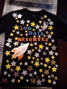 a black shirt with stars on it that says 100 days brighter