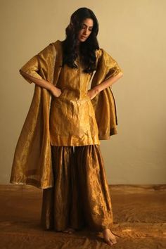 Ochre kurta with zardozi embroidery and round-neck. Paired with sharara.
Components:2
Neckline:Round
Sleeve Length:Three quarter
Fabric:Handloom Tissue 
Color:Yellow
Note: Dupatta worn by the model is not for sale - Aza Fashions Gold Dupatta, Kurta And Sharara Set, Kurta And Sharara, Sharara Designs, Zardosi Embroidery, Kurta Sharara, Zardozi Embroidery, Embroidered Border, Sharara Set