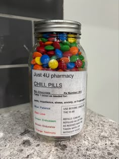 a jar filled with jelly beans sitting on top of a counter