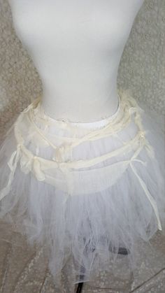 a mannequin wearing a white tutu skirt